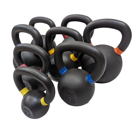 Set of black cast iron kettlebells with powder-coated handles, each marked by colored bands and weight labels ranging from.