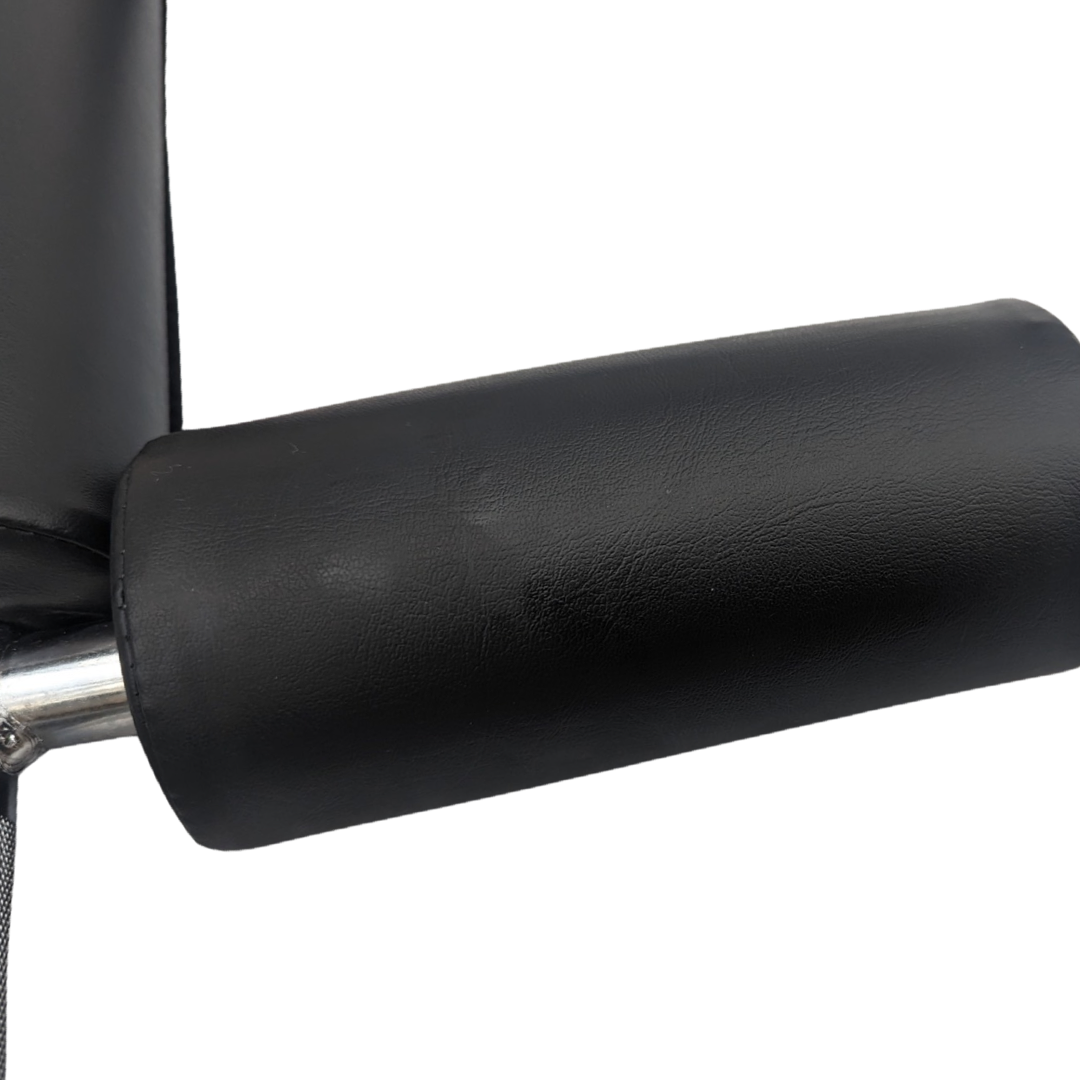 Black padded shoulder pad on silver metal safety squat bar with textured grip surface.