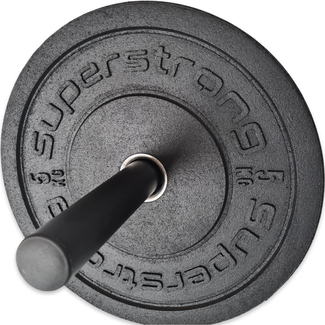 Black Superstrong branded bumper plate loaded on a black wall-mounted storage horn with metal sleeve.
