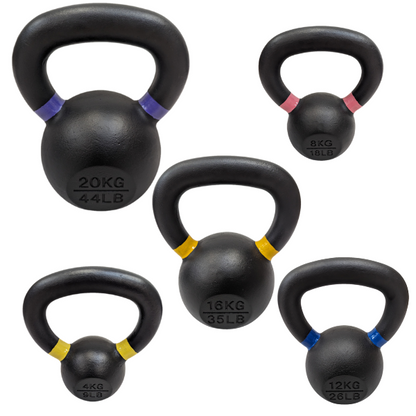 Set of four black cast iron kettlebells with powder coating, each marked with weight and color-coded bands.